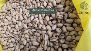 Extra-long Akbari in-shell pistachios on a white background, known as the luxury variety.